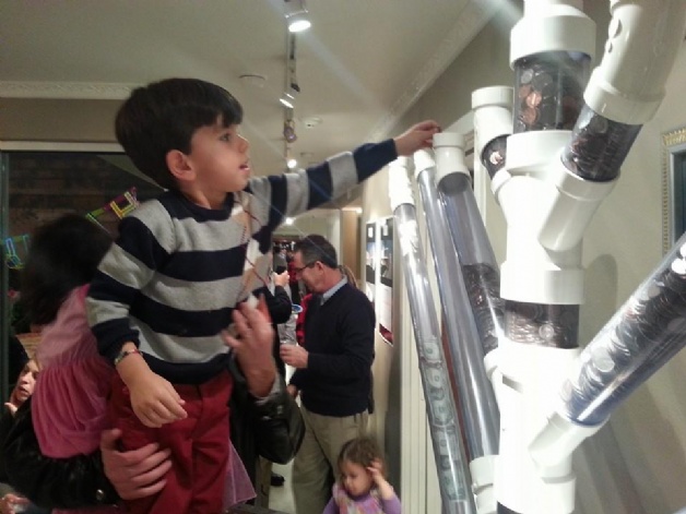 Child Filling Coin Menorah